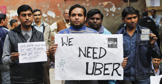 Uber taxi drivers hold placards during a protest against the ban on online taxi services in New Delhi