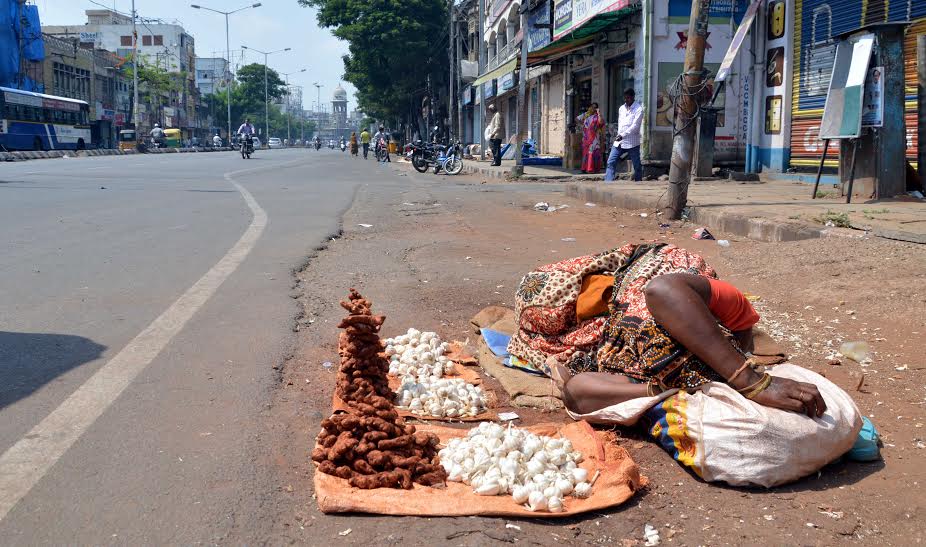 Hot Summer: A Women road side Garlic and ginger seller cover her face relax in hot summer as she waits for the customers Osman Jung in Hyderabad on Sunday.Pic:Style photo service.